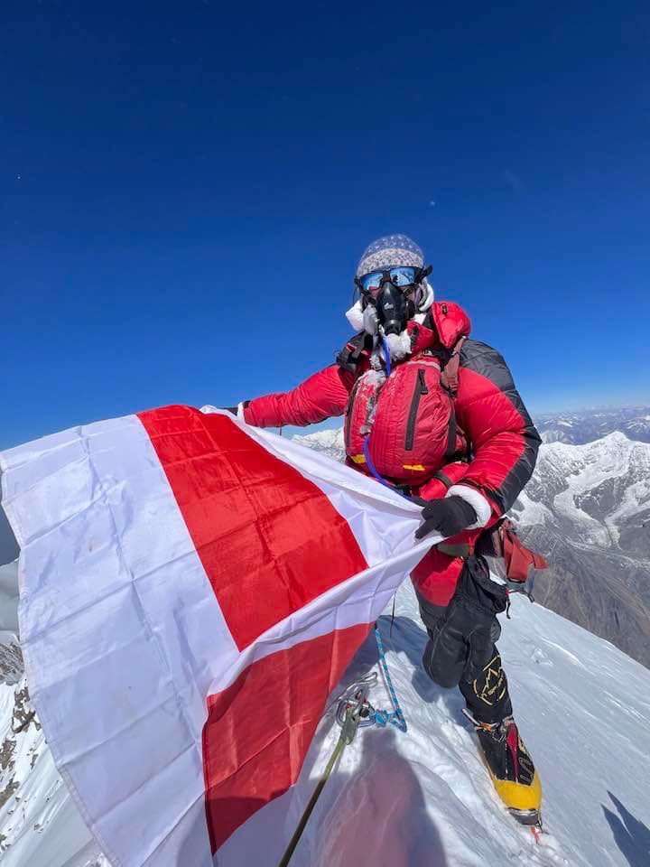 Liliya Ianovskaia on the summit of Annapurna I holding the Belarusian historic flag, April 7, 2025