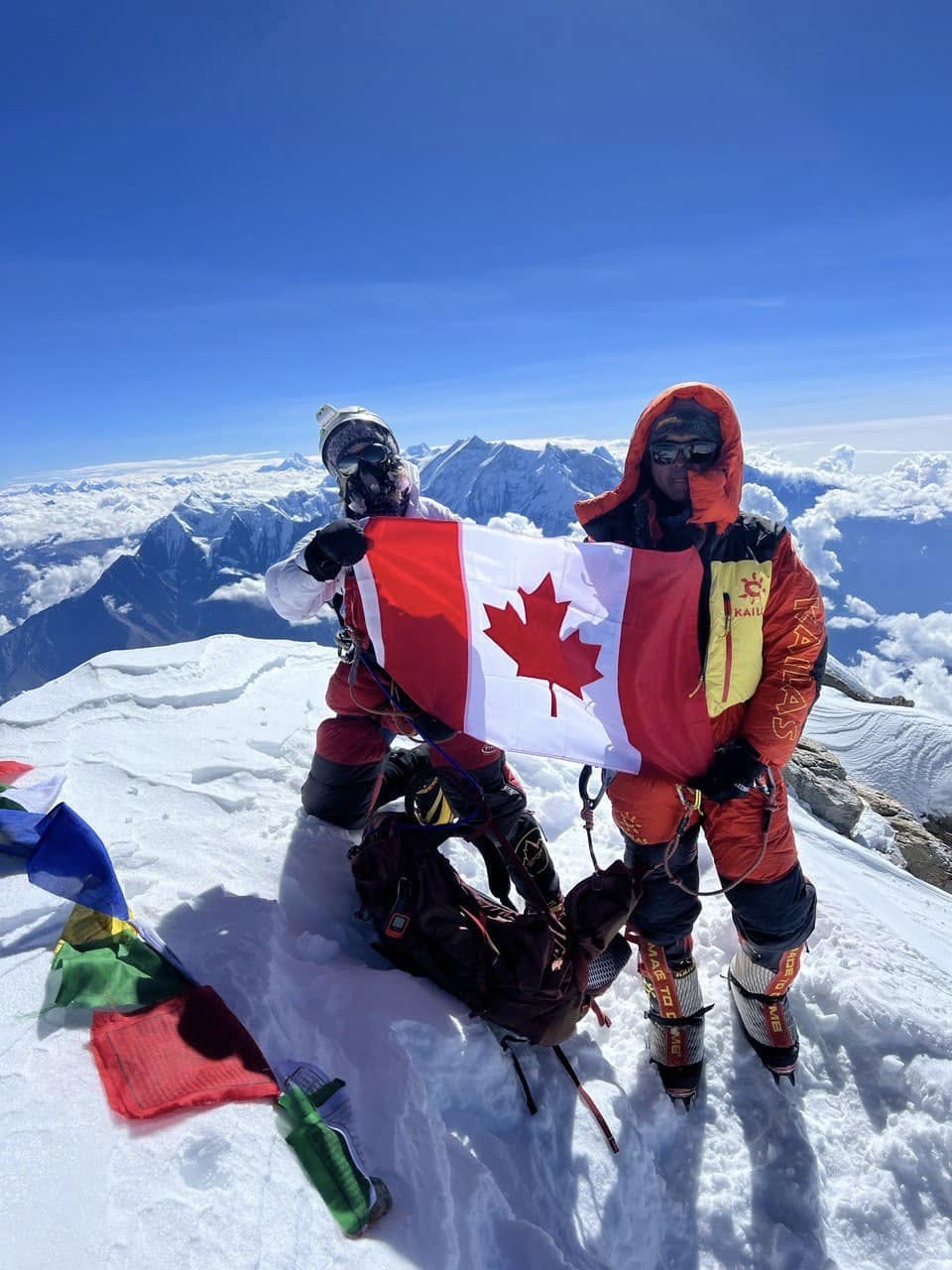 Liliya Ianovskaia on Dhaulagiri holding the Canadian flag above the Himalaya, September 30, 2023