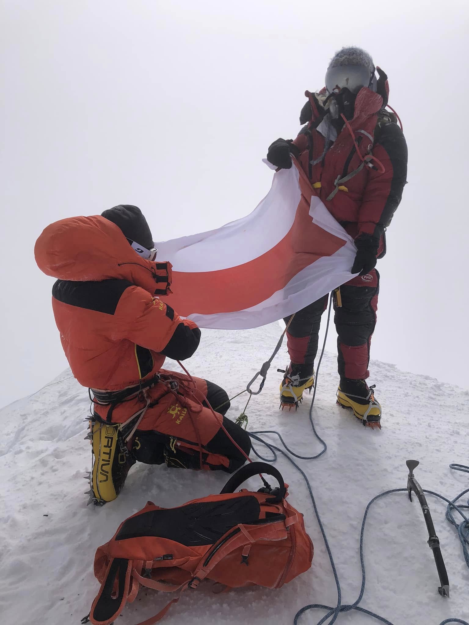 Liliya Ianovskaia in red down suit and oxygen mask high on Gasherbrum II, August 2022