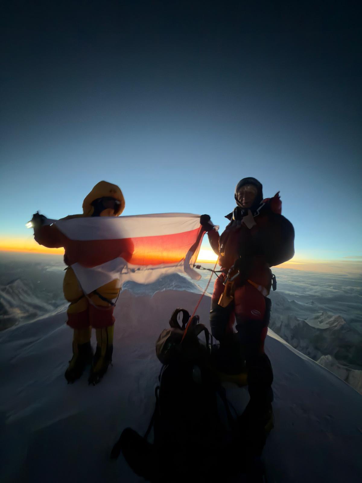 Liliya Ianovskaia on the summit of Kangchenjunga holding the Belarusian historic flag, May 23, 2026