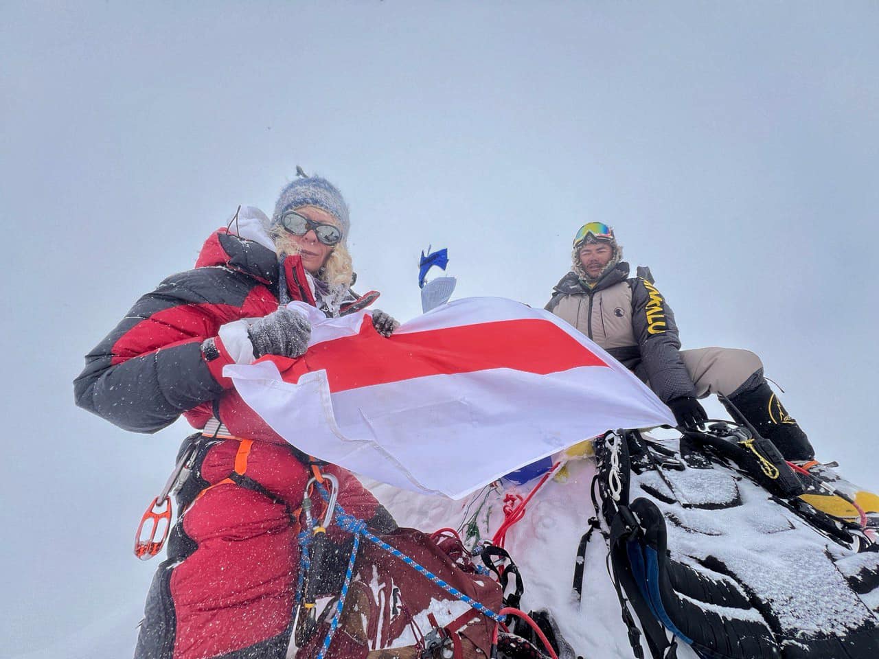 Liliya Ianovskaia on the summit of Makalu holding the Belarusian historic flag in a storm, May 6, 2024